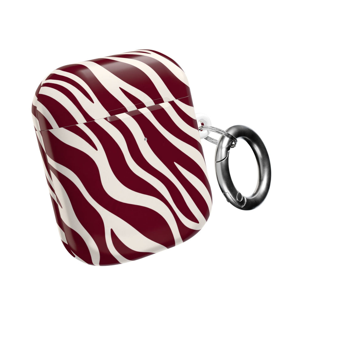 Sunday Theory maroon and cream zebra stripe glossy polycarbonate AirPod case with a silver carabiner clip.