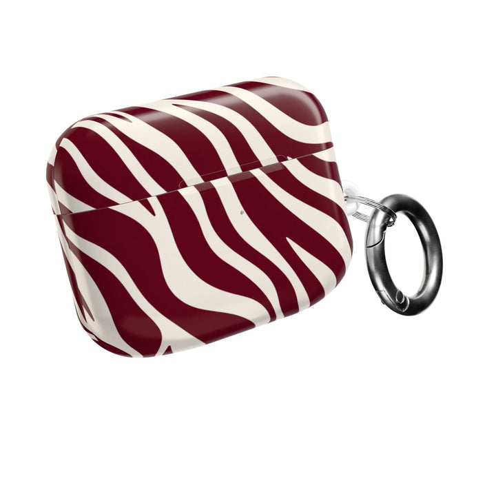 Sunday Theory maroon and cream zebra stripe glossy polycarbonate AirPod case with a silver carabiner attachment.