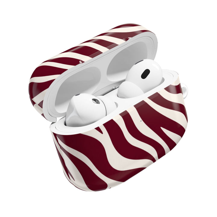 Sunday Theory maroon and cream zebra stripe glossy polycarbonate protective case for AirPods with earbuds inside
