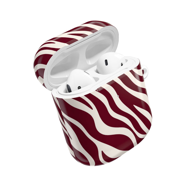 Sunday Theory maroon and cream zebra stripe glossy polycarbonate AirPod case with earbuds inside