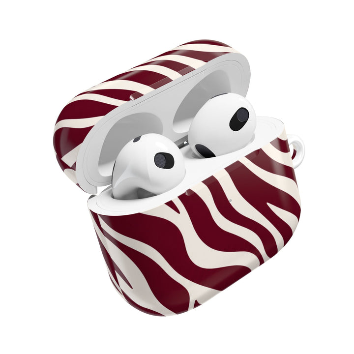 Sunday Theory maroon and cream zebra stripe glossy polycarbonate AirPod case with white earbuds inside