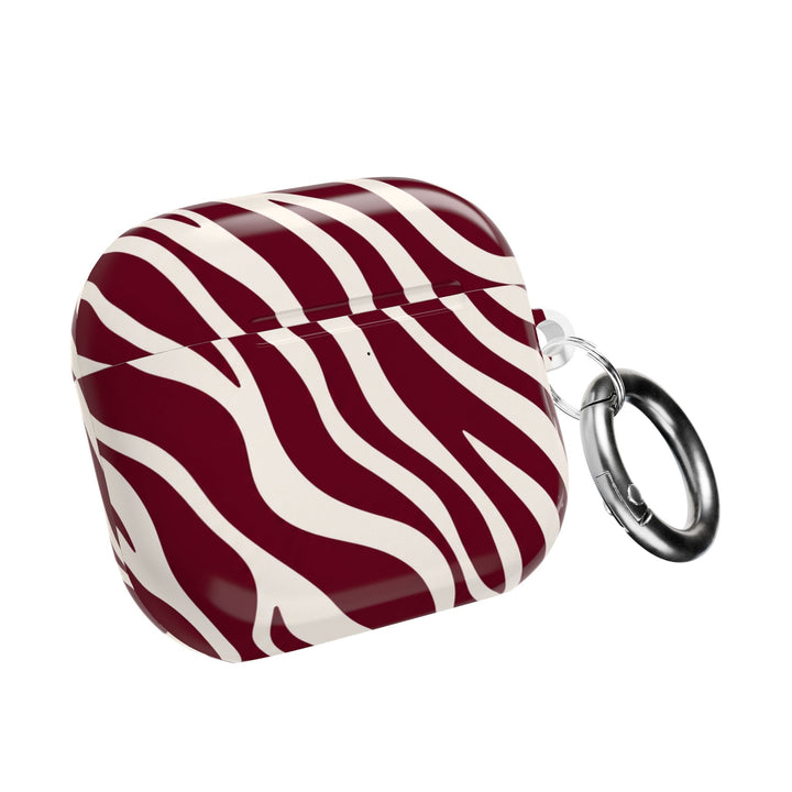 Sunday Theory maroon and cream zebra stripe polycarbonate AirPod case with a silver carabiner and glossy finish.