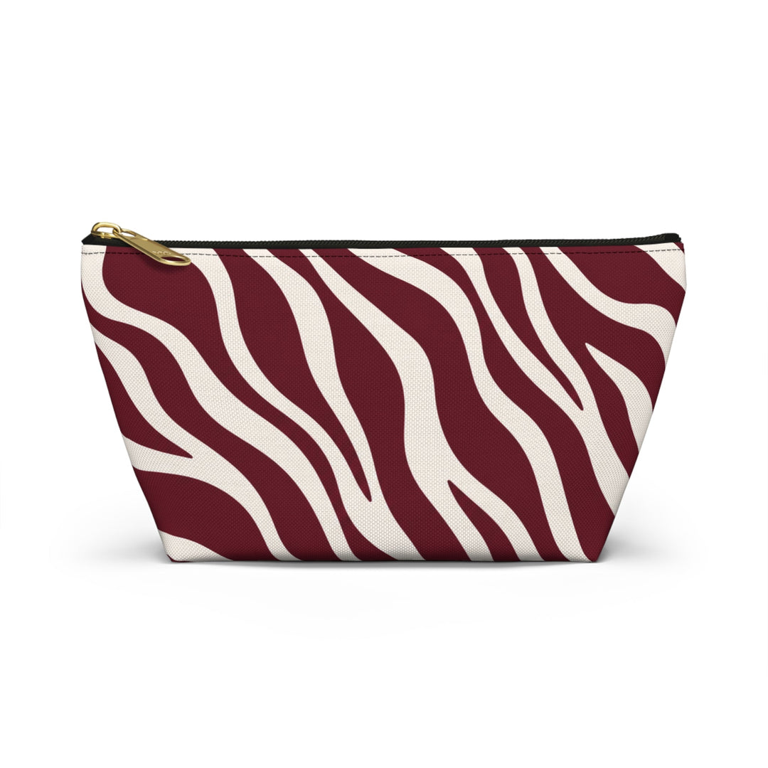 Sunday Theory maroon and cream zebra print polyester accessory pouch with a gold zipper and stable T-bottom base.