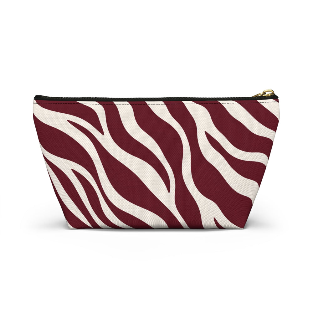 Sunday Theory maroon and cream zebra print accessory pouch with a T-bottom base and gold zipper pull.