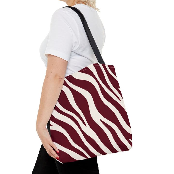 Sunday Theory maroon and cream zebra print polyester tote bag with black handles worn over the shoulder
