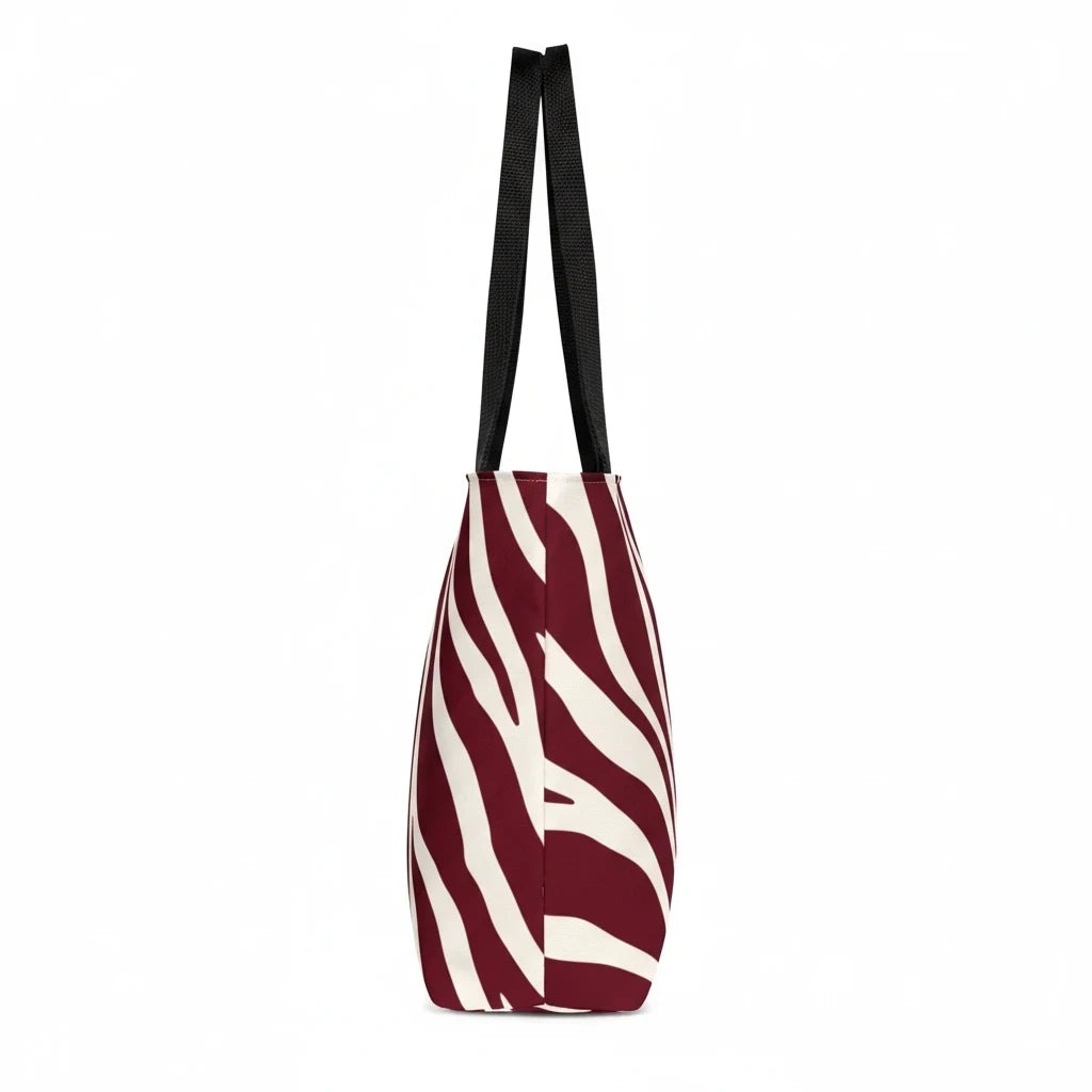 Sunday Theory maroon and cream zebra print polyester tote bag with black handles, side view