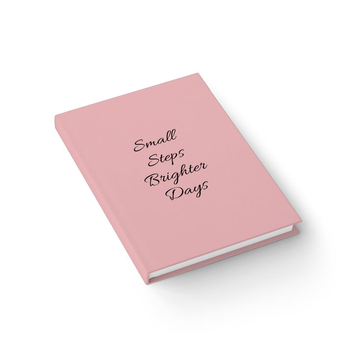 Sunday Theory soft pink hardcover journal with Small Steps Brighter Days text in a clean, minimalist design.