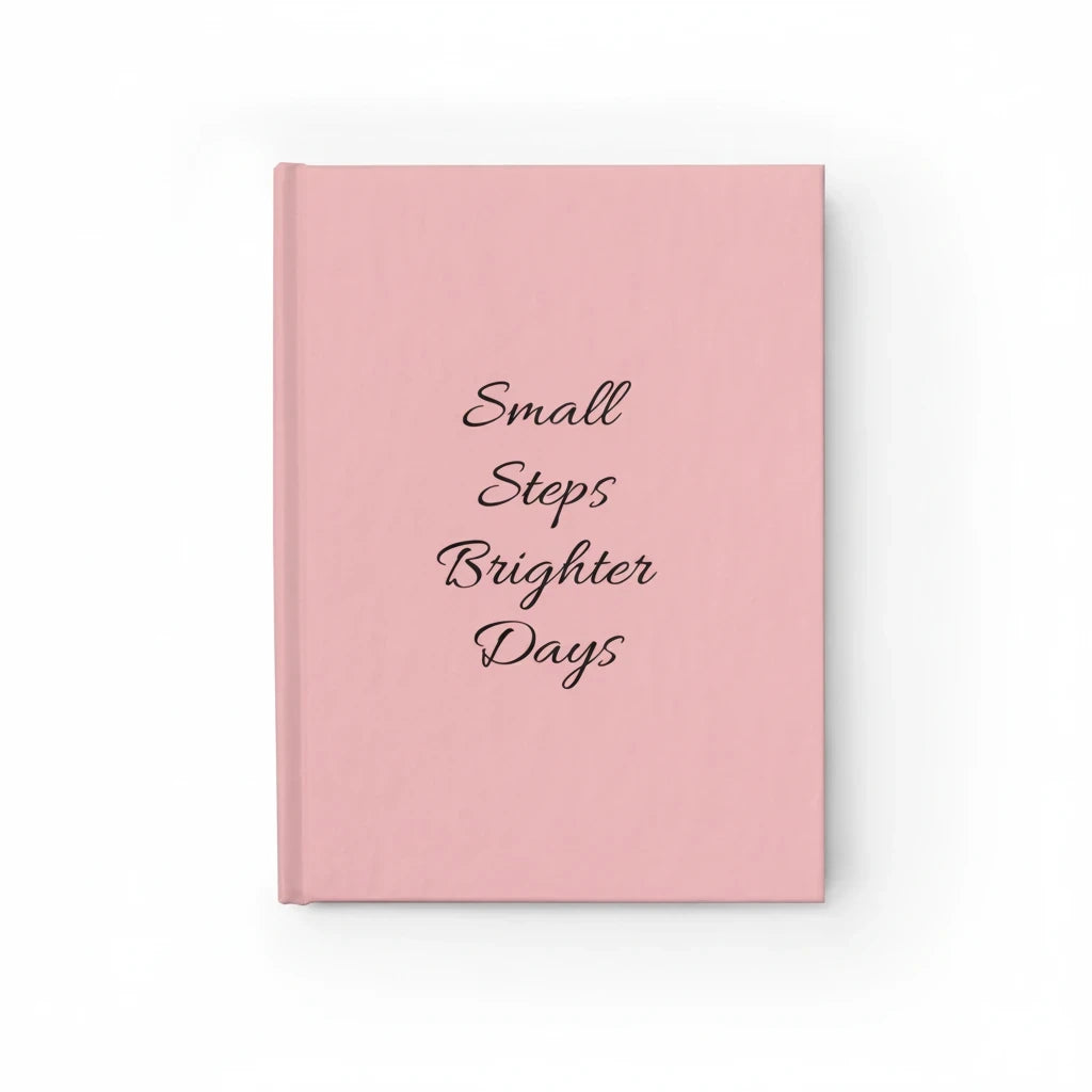 Sunday Theory soft-pink hardcover journal with Small Steps Brighter Days text in elegant black script on the cover.