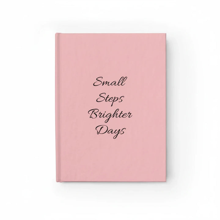 Sunday Theory soft-pink hardcover journal with Small Steps Brighter Days text in elegant black script on the cover.