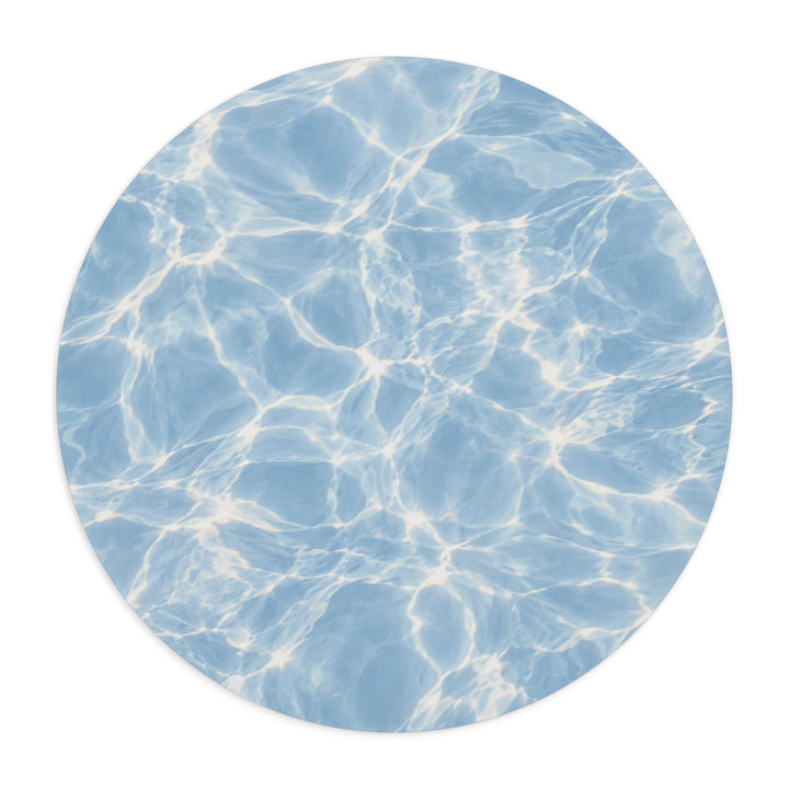 Sunday Theory round mouse pad featuring a blue water ripple pattern with sunlit reflections on neoprene material