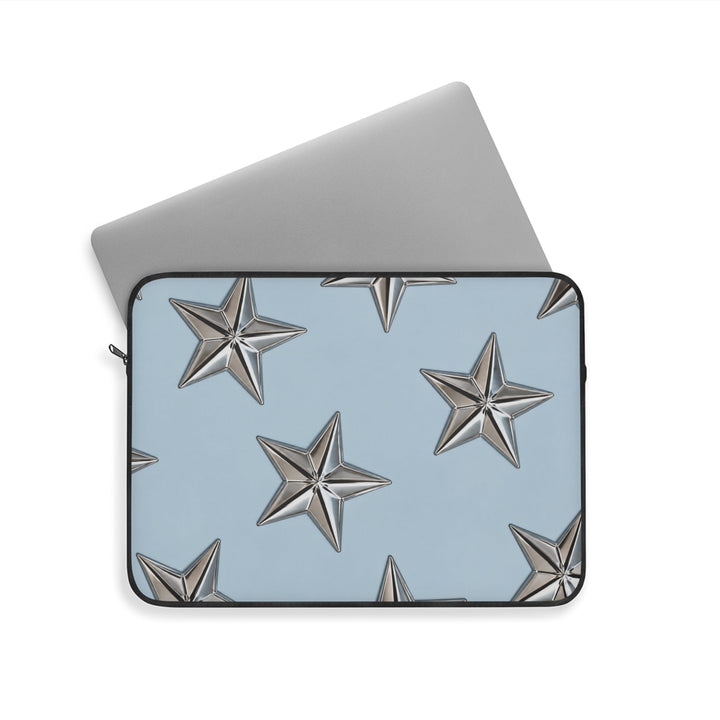 Sunday Theory sky blue laptop sleeve featuring raised metallic star patterns and a protective fleece-lined interior.